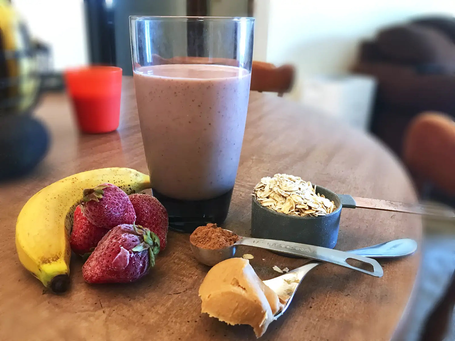 Homemade Oat Buster smoothie made with strawberries, bananas, oatmeal, peanut butter, and cocoa powder.