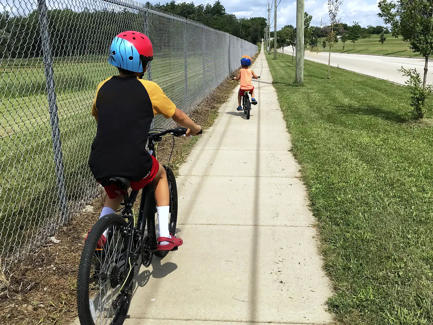 Two boys riding their bikes during a summer family adventure.