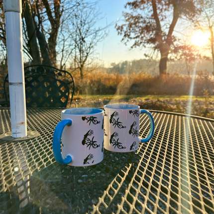 After Life Coffee mug set sitting on metal table over looking the morning sunrise in Madison, Wisconsin on a cold fall day.