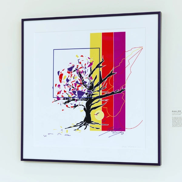 Framed abstract artwork with a tree design on a white wall