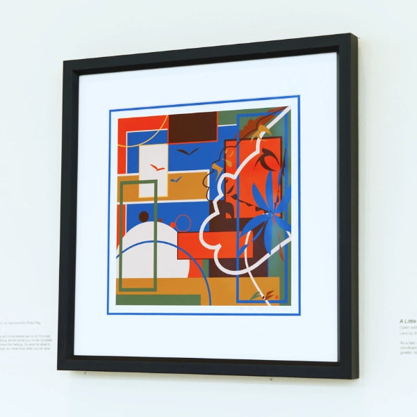 Framed abstract artwork with geometric shapes on a white wall