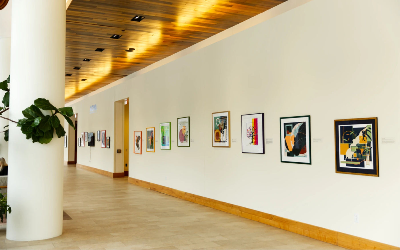 Gallery wall of 15 framed abstract art prints displayed at Saint John’s on the Lake in Milwaukee associated with Museum of Wisconsin Art exhibition
