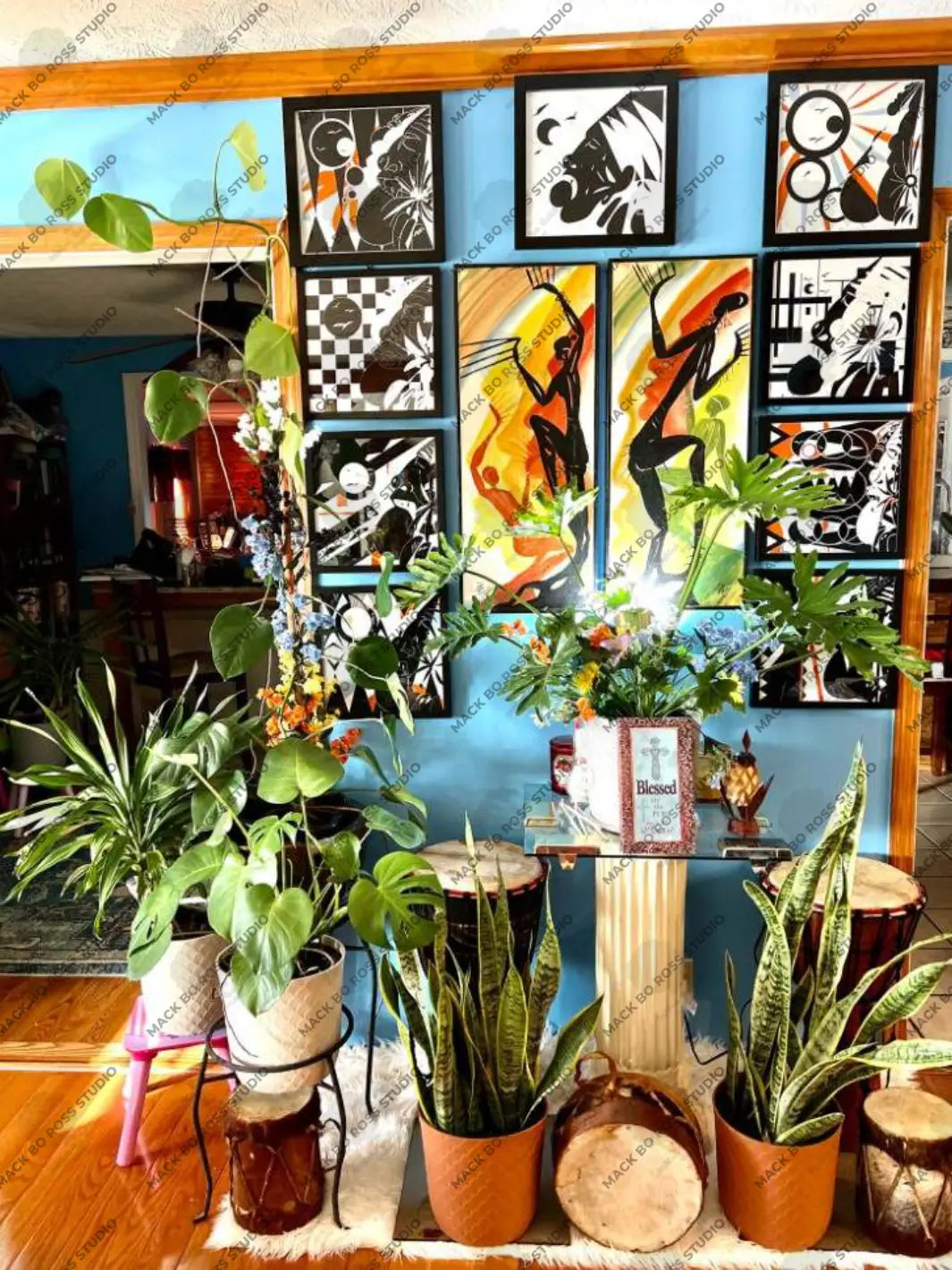 A collection of African-inspired artwork by Mack Bo Ross and his grandfather, blending modern creativity with traditional heritage.