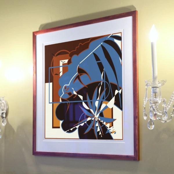 Framed abstract artwork on a wall with chandelier in the background