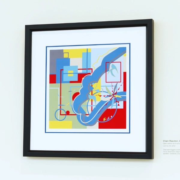 Framed abstract artwork with geometric shapes on a white wall