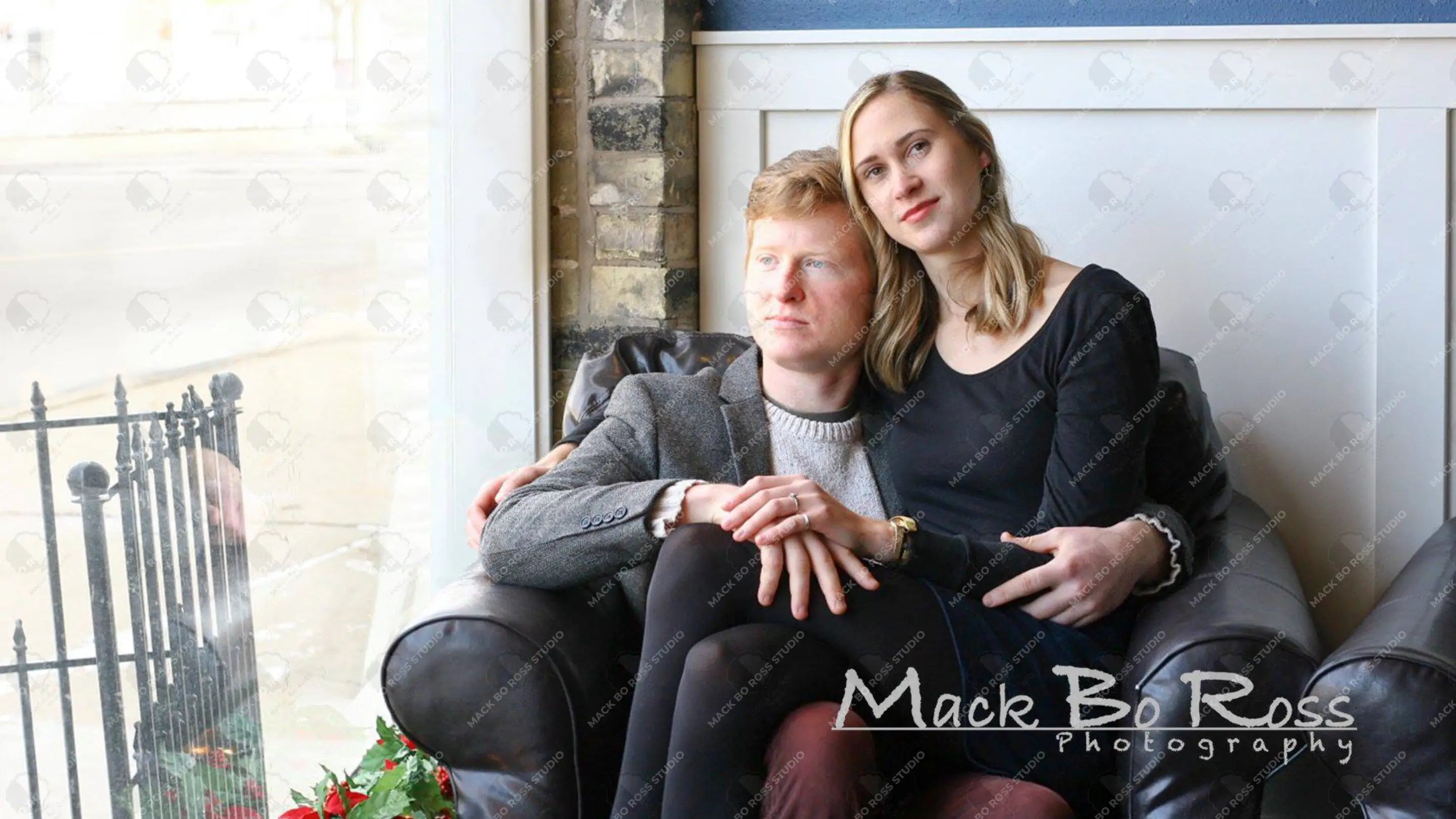 Engaged couple sitting together in a cozy coffee shop, smiling and enjoying a quiet moment