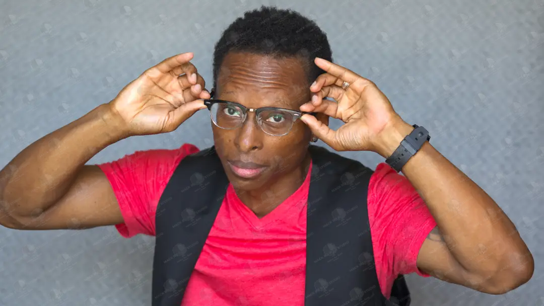 Person wearing glasses with a plain background