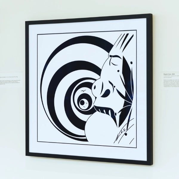 Framed black and white abstract artwork on a wall