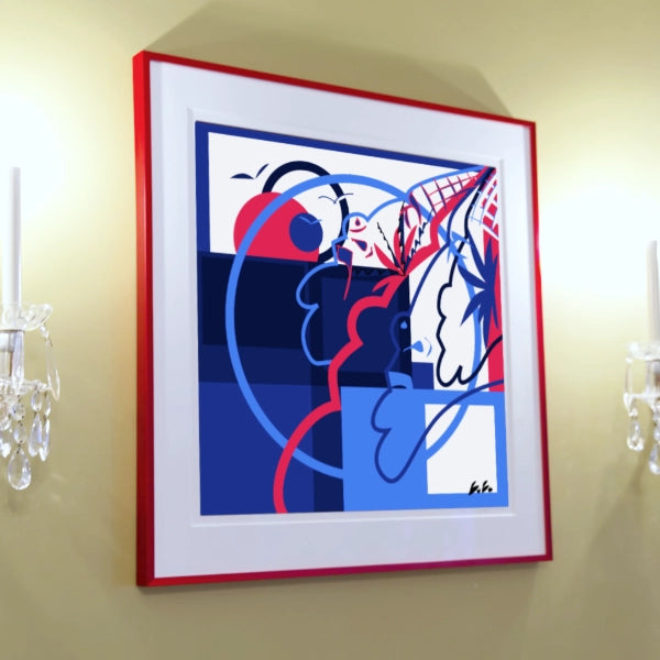 Framed abstract artwork with red, blue, and white colors on a beige wall.
