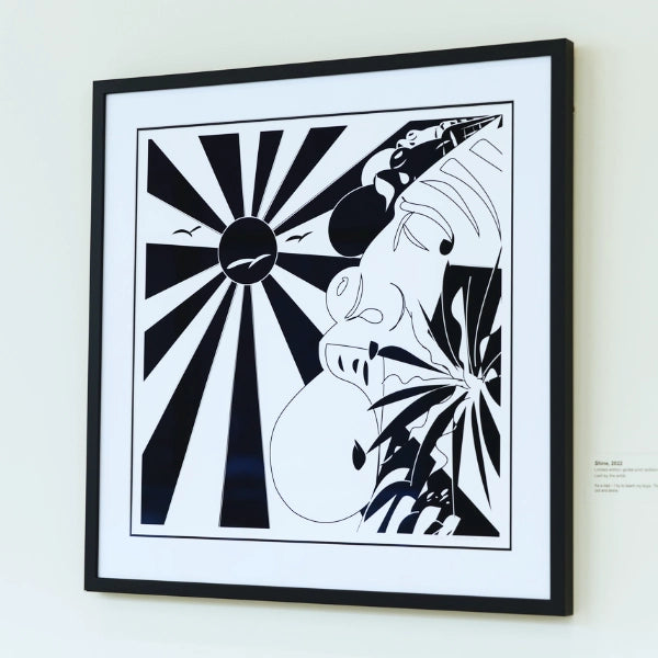 Framed black and white abstract artwork on a light gray wall