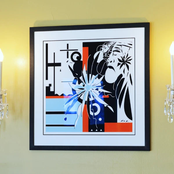 Framed abstract artwork with geometric shapes on a yellow wall.